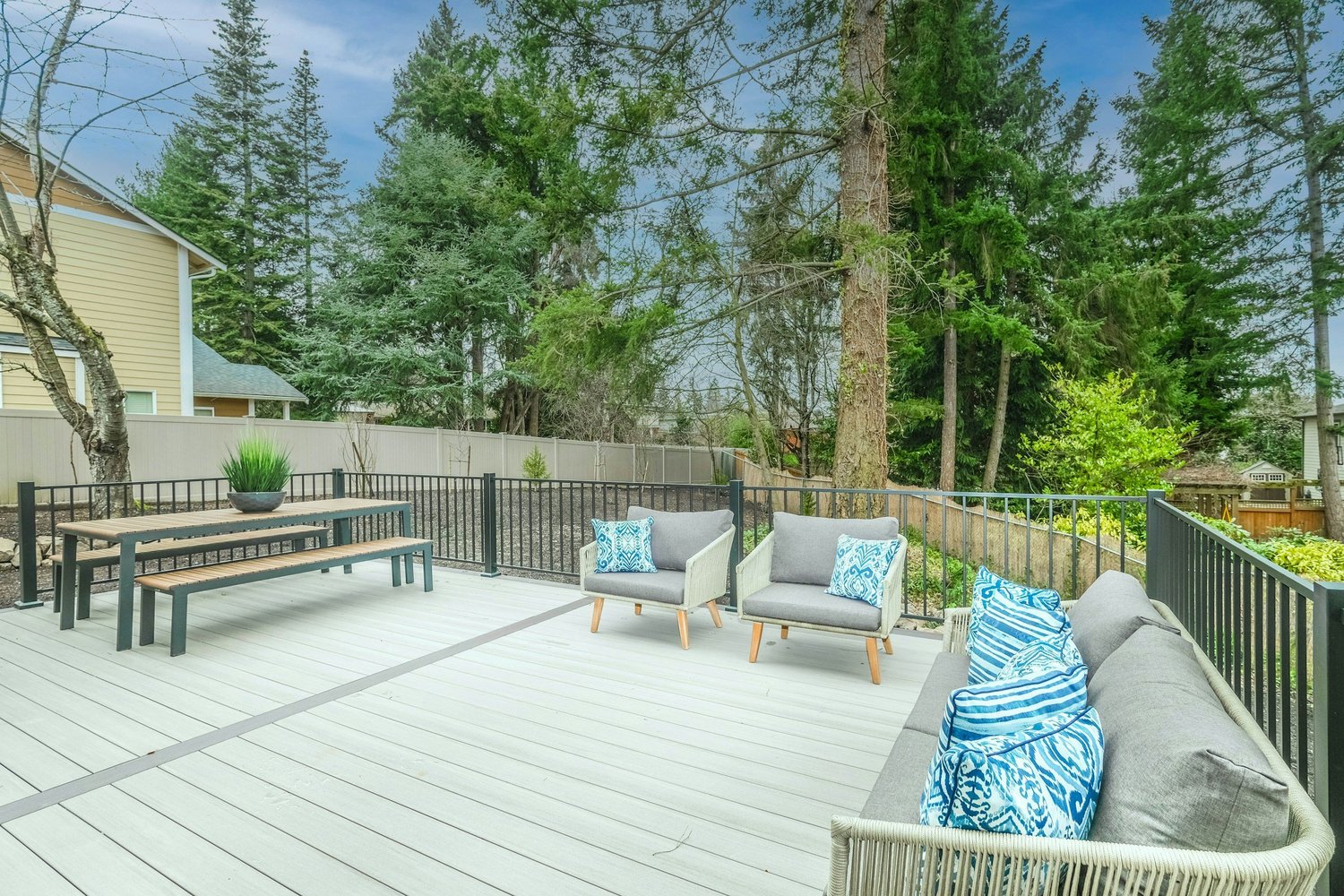Outdoor deck with lounge seating and black railings