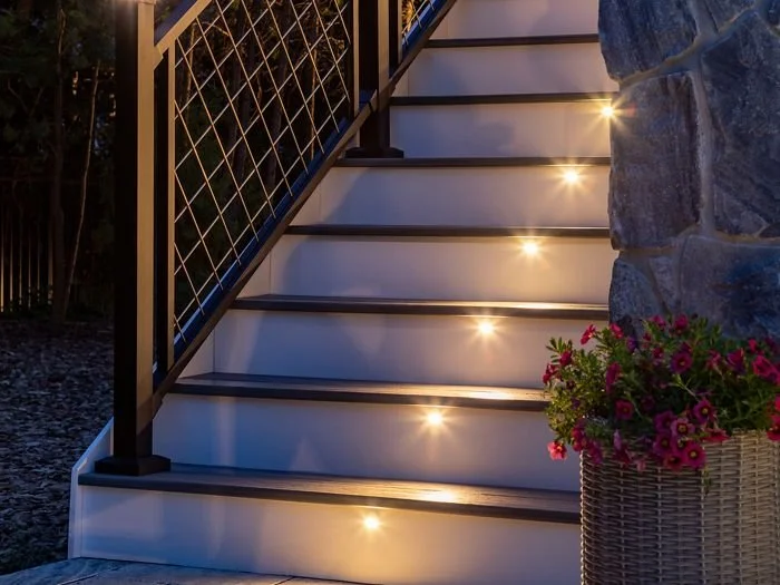 Outdoor stairs illuminated with integrated deck lighting